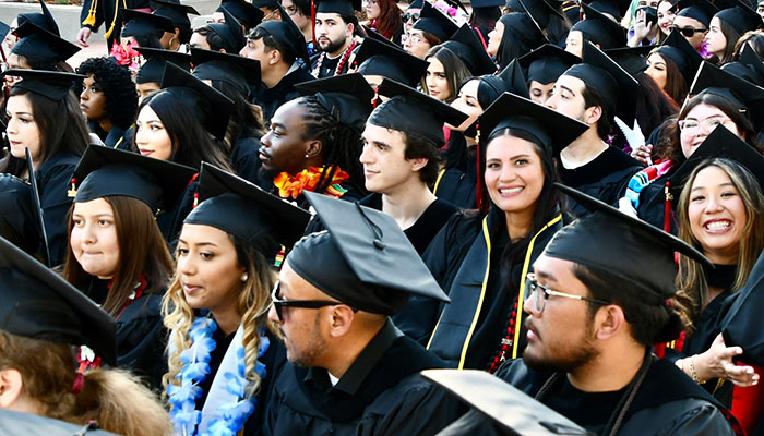 large group of graduating students in cap and gown