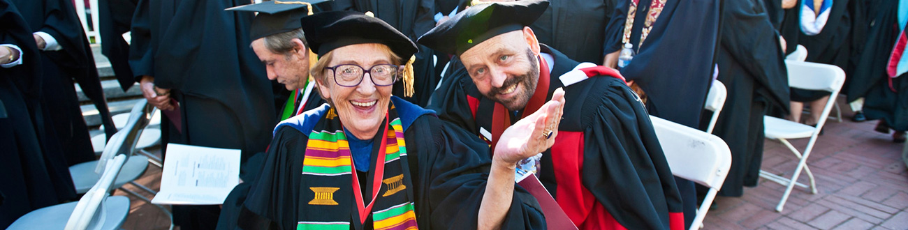 two faculty during graduation