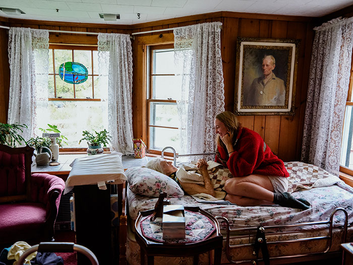 bedroom scene with woman sitting on bed