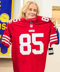 GaeAnn Spence holding a jersey for auction