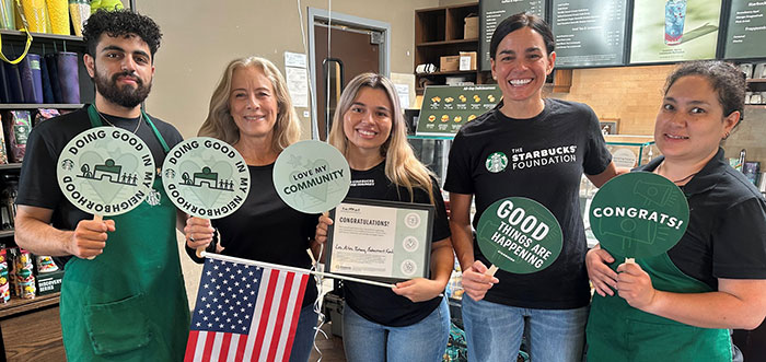 4 students next to GaeAnn Spence