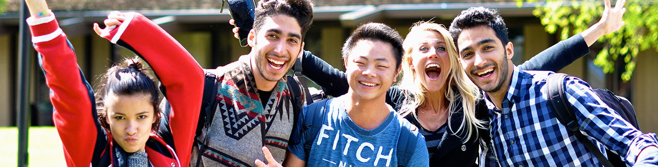 Group of energetic students on lawn